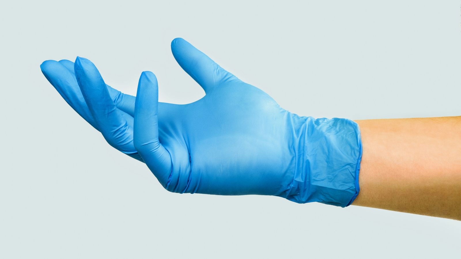 Hand in a blue nitrile disposable glove